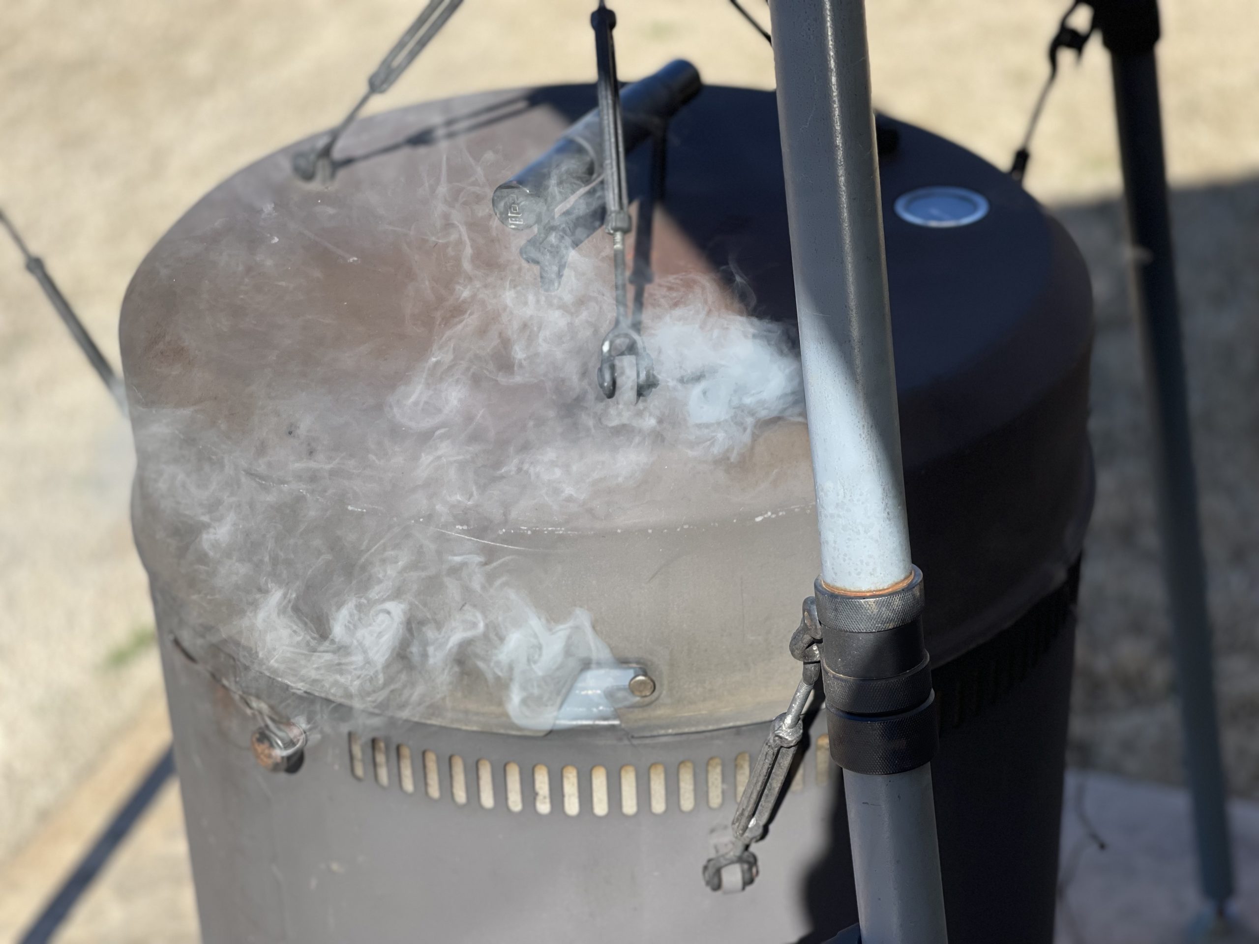 Smoke coming out of a black smoker.