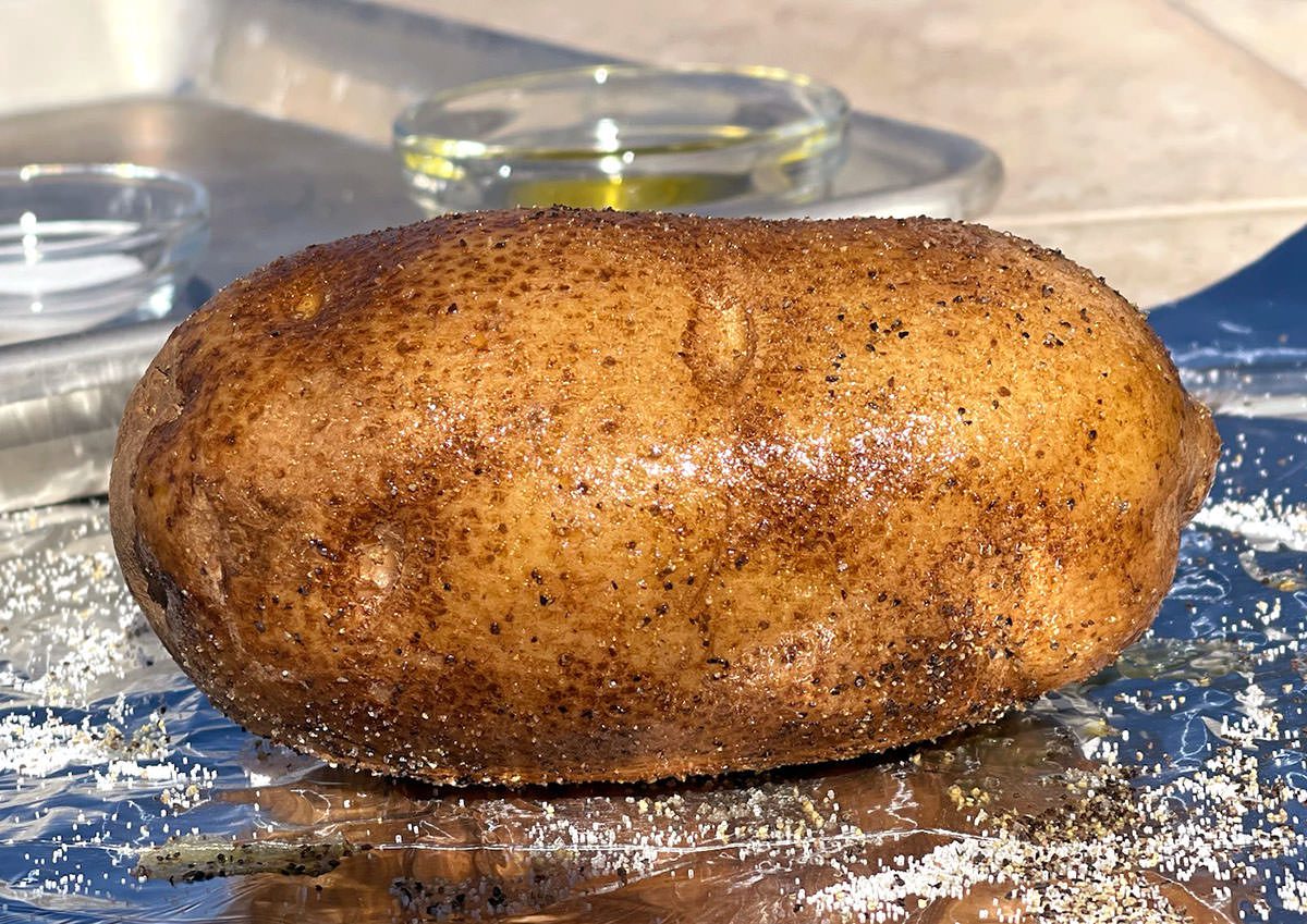 Baked potato on a sheet of foil.